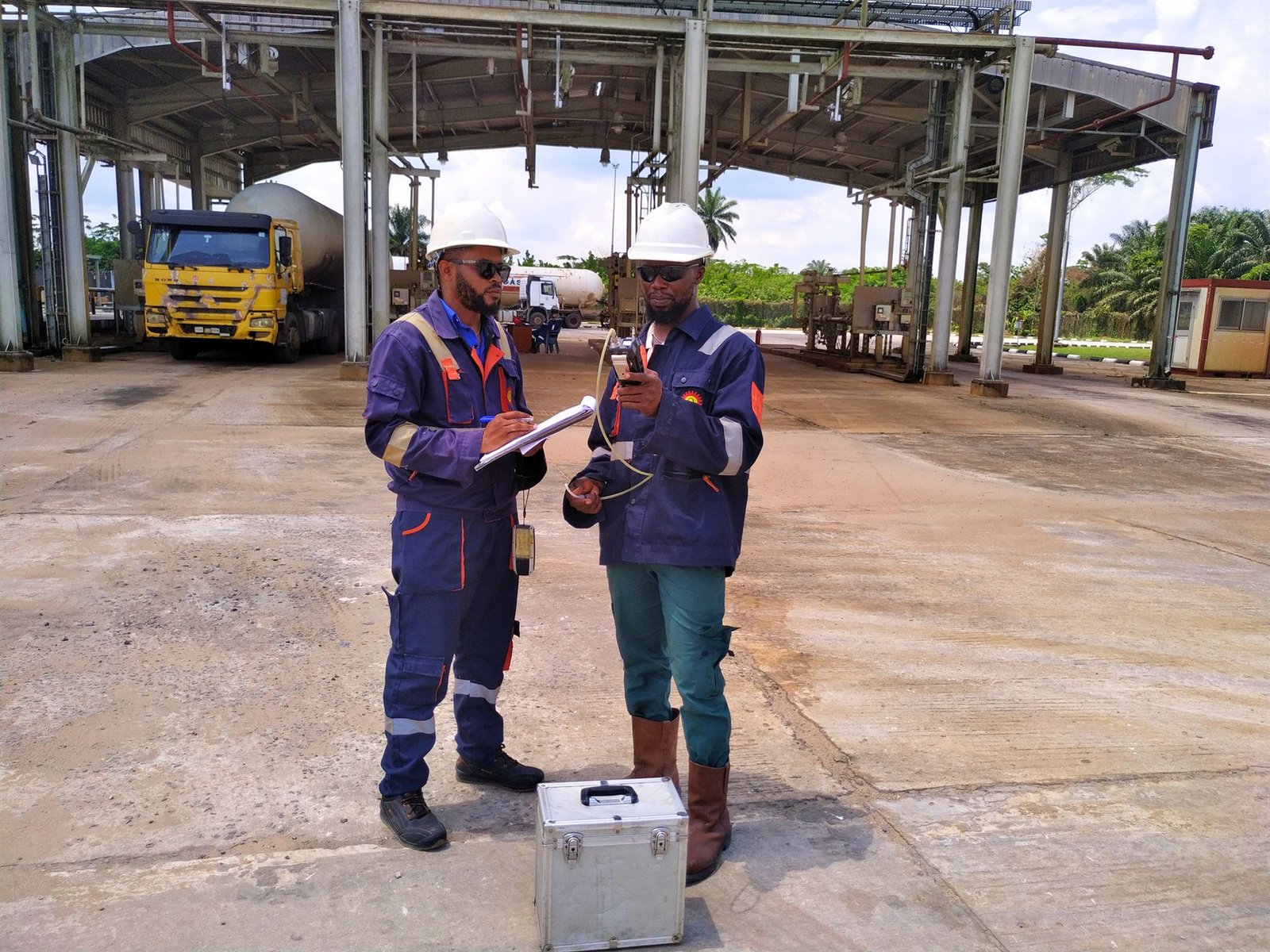 Two Quatenary engineers recording ambient gas readings at a terminal facility