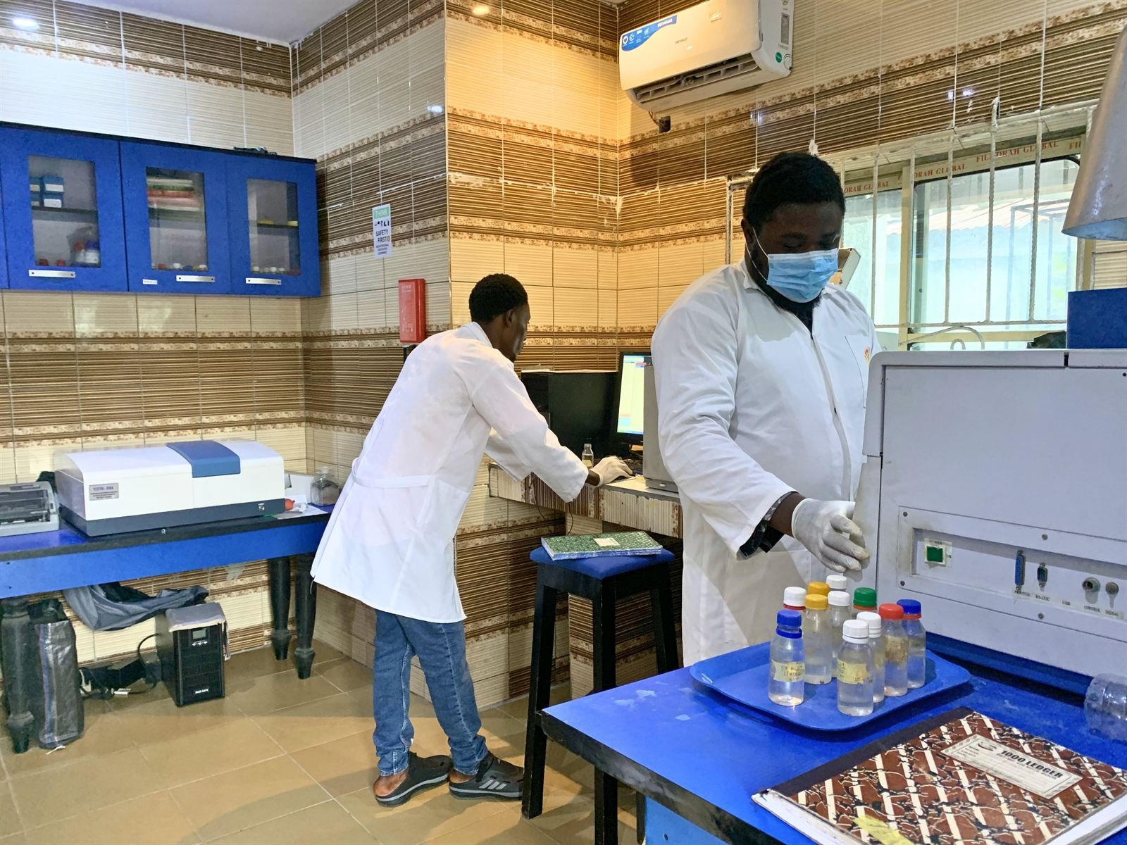 Two Quatenary analysts at instruments in the environmental and bio-monitoring laboratory
