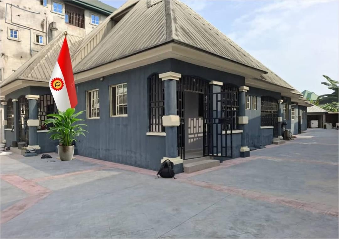 Quatenary International's Port Harcourt office building with the company flag